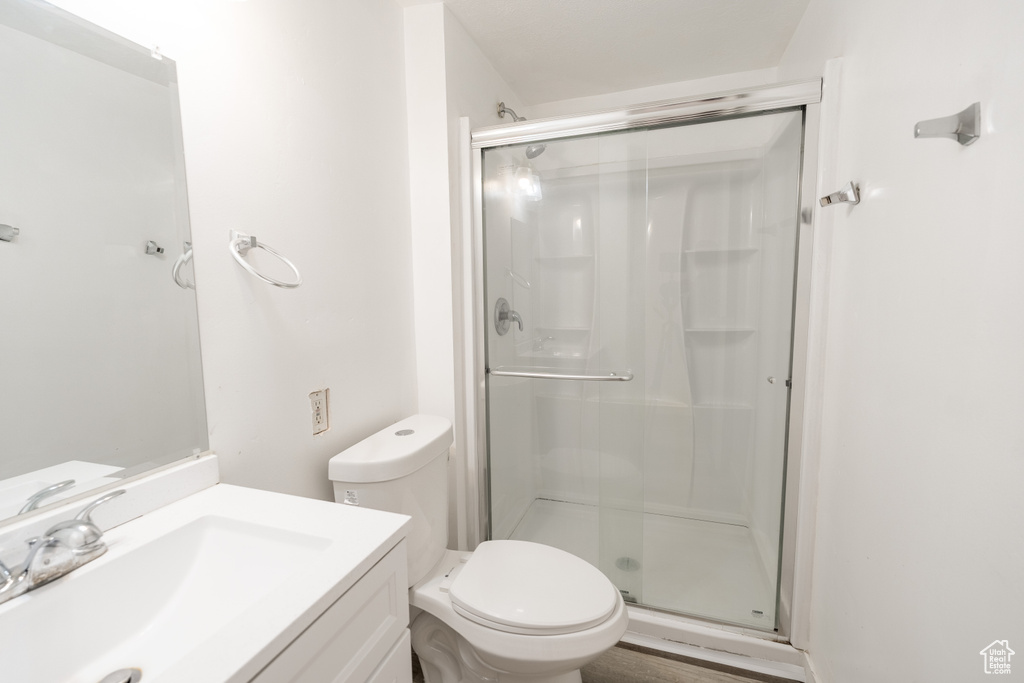 Full bath featuring a stall shower and vanity