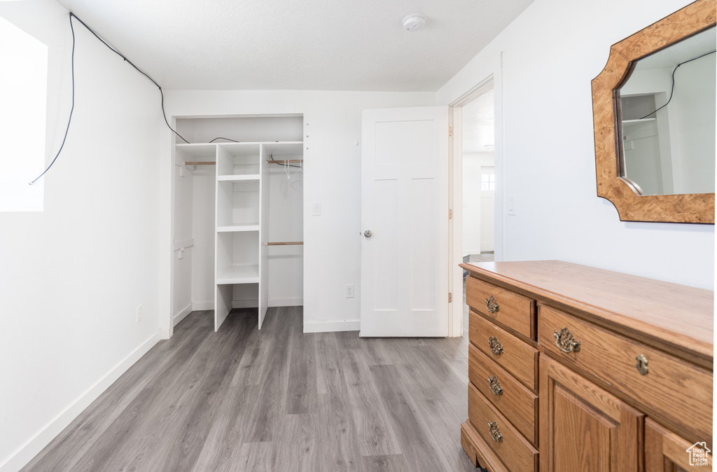 Unfurnished bedroom featuring light wood-style floors and a closet