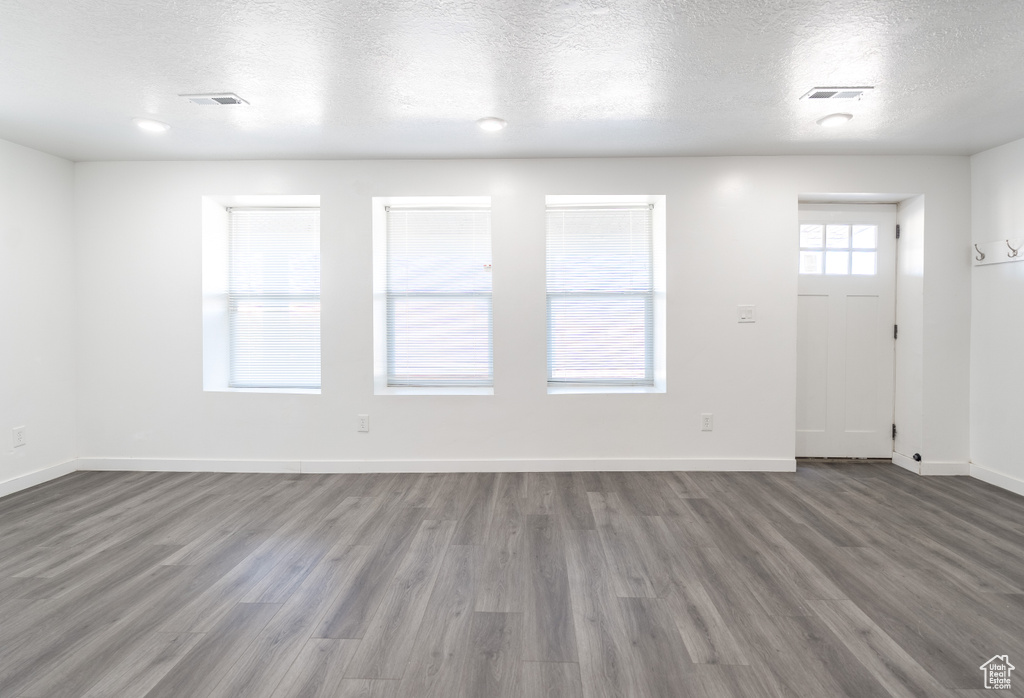 Foyer featuring wood finished floors and a textured ceiling