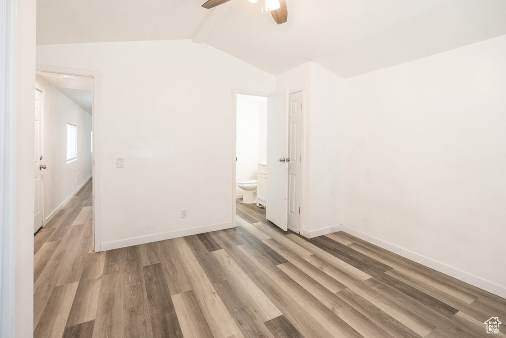 Unfurnished bedroom with light wood-style flooring, connected bathroom, and ceiling fan