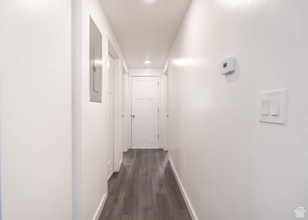 Corridor with dark wood finished floors and recessed lighting