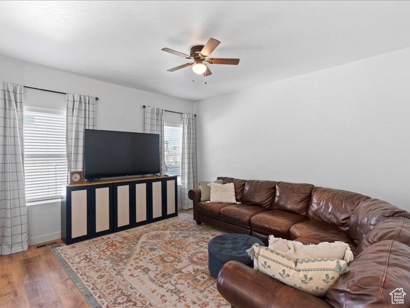 Living area featuring a ceiling fan and wood finished floors