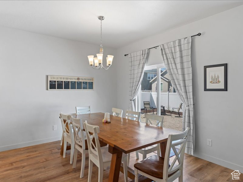 Dining area featuring a chandelier and wood finished floors
