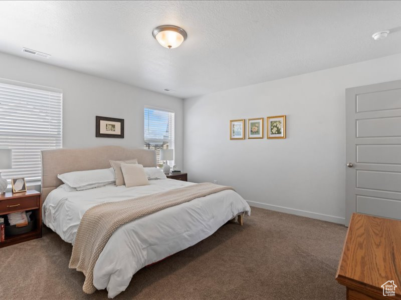 Carpeted bedroom with baseboards
