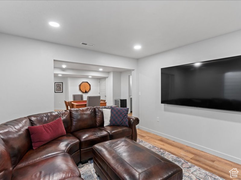 Living room featuring light wood-type flooring and recessed lighting