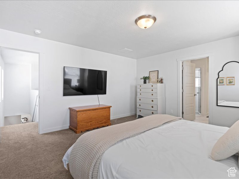 Carpeted bedroom featuring baseboards