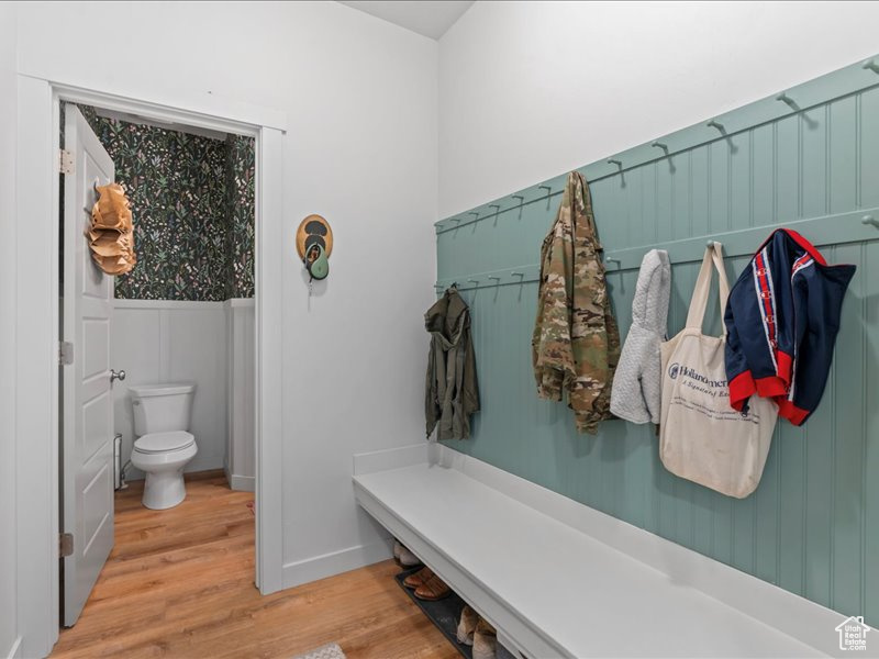 Mudroom with wood finished floors and baseboards
