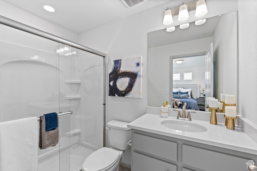 Full bath featuring connected bathroom, vanity, and a shower stall