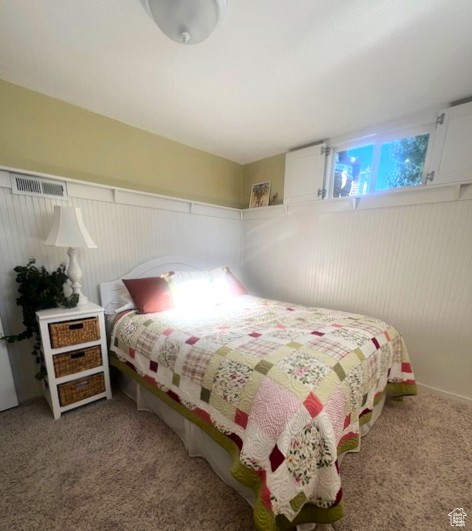 Bedroom with carpet and a wainscoted wall