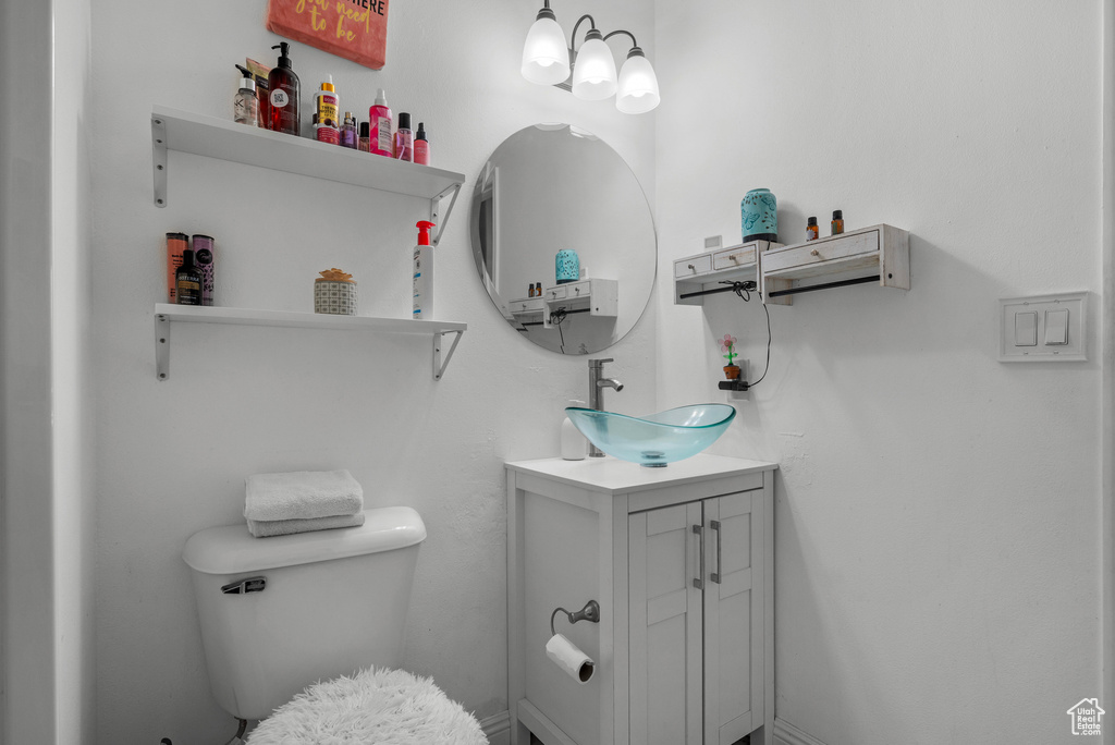 Half bathroom with vanity and toilet