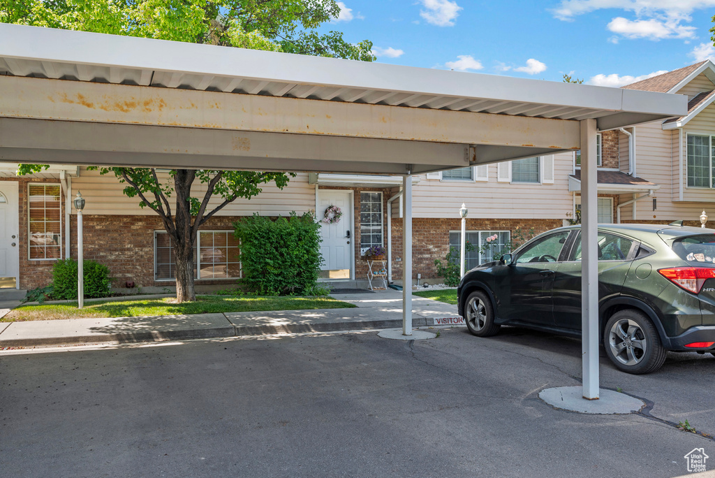 View of front of home with covered parking and brick siding