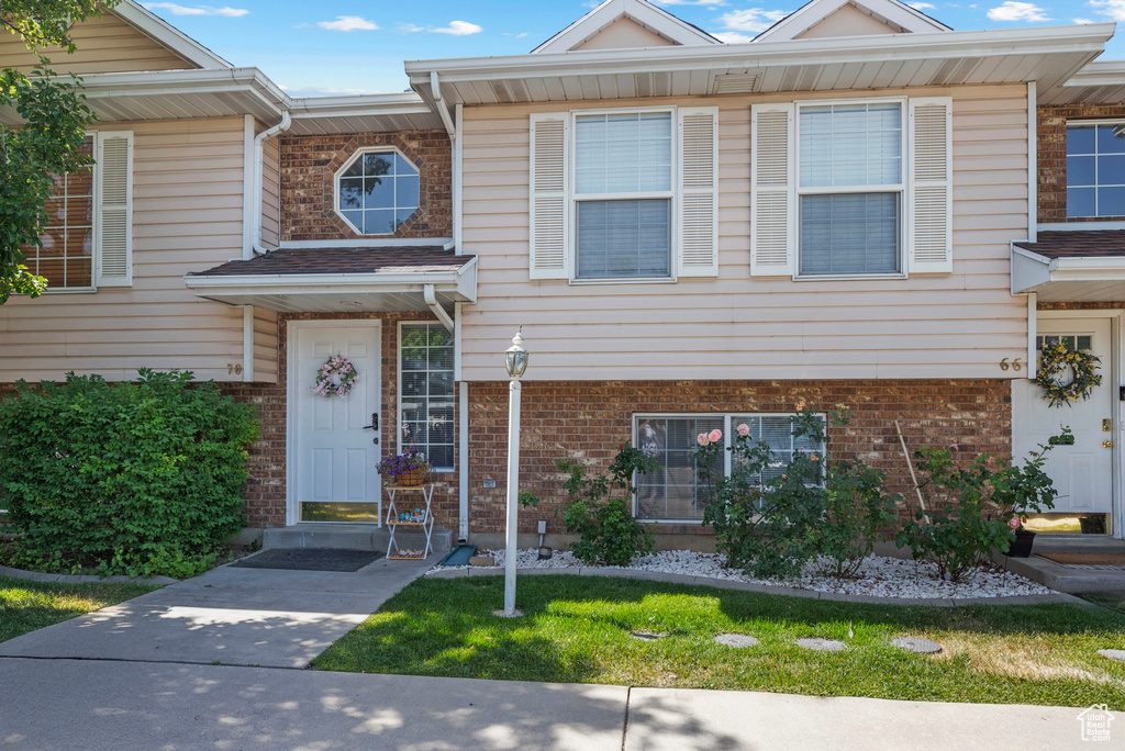 View of property with brick siding