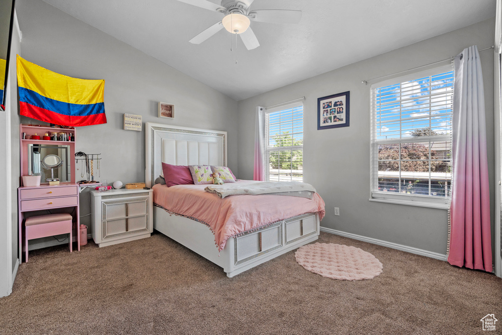 Bedroom featuring carpet, vaulted ceiling, and a ceiling fan