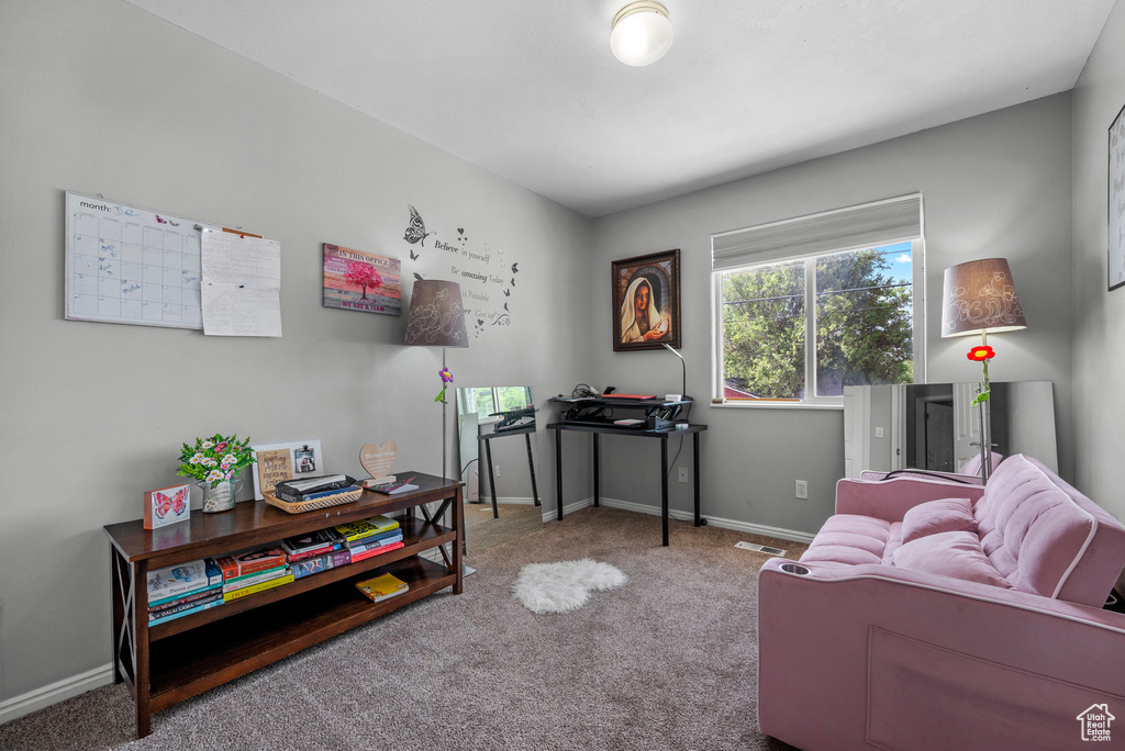 Carpeted office space with baseboards