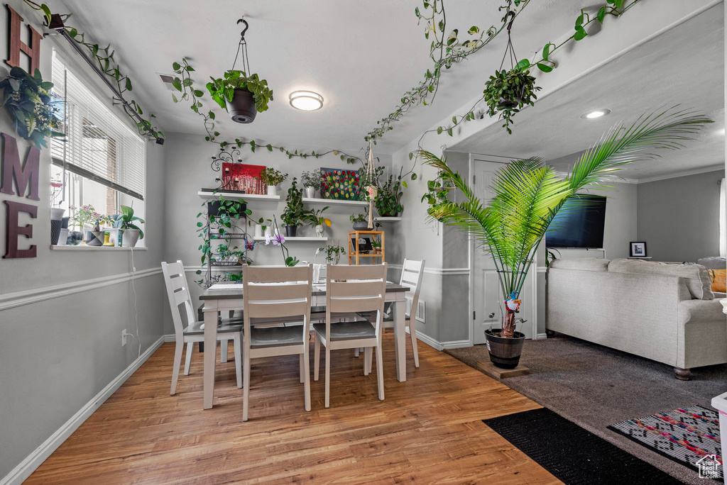 Dining space featuring wood finished floors and baseboards