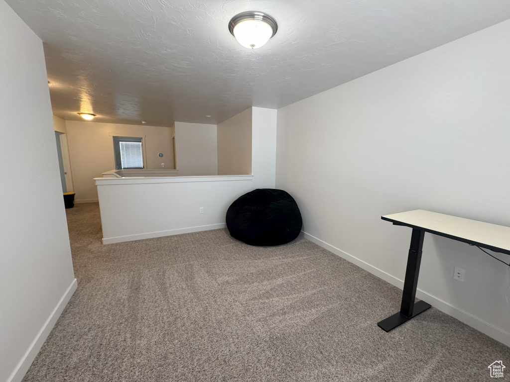 Carpeted spare room with baseboards
