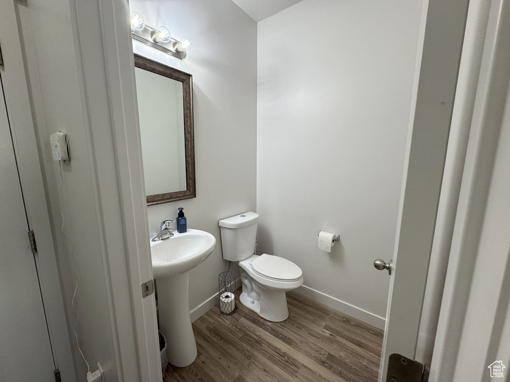Bathroom featuring toilet and wood finished floors