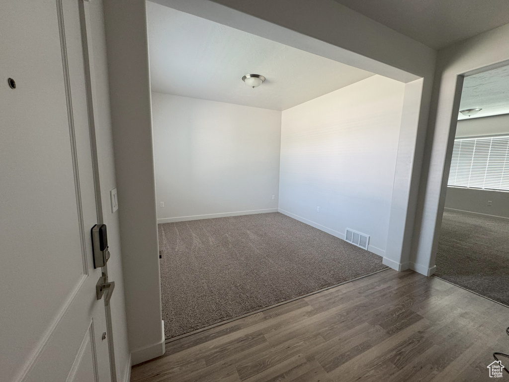 Spare room featuring carpet and wood finished floors