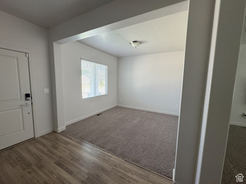 Foyer entrance featuring wood finished floors and carpet floors
