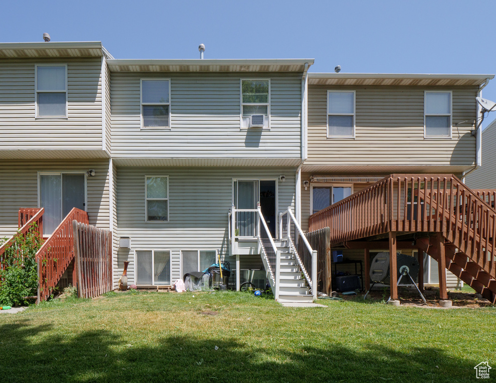 Back of property featuring stairs, a wooden deck, a yard, and cooling unit