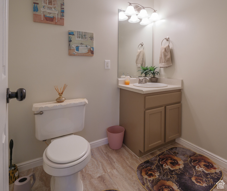 Bathroom with vanity and wood finished floors