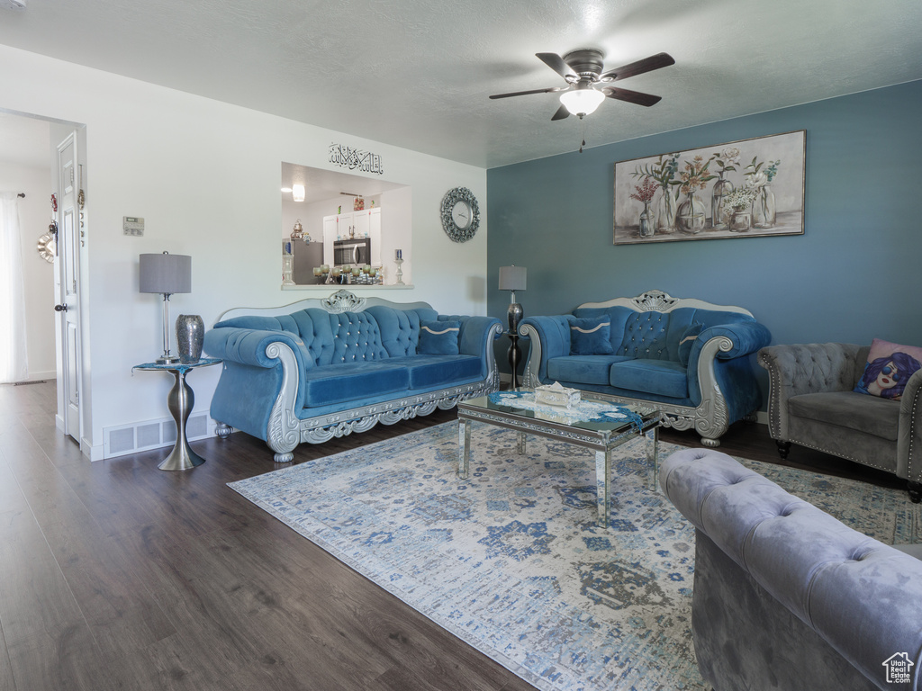 Living area with wood finished floors and ceiling fan
