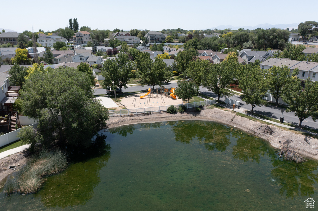 Aerial view of property and surrounding area with nearby suburban area and a large body of water