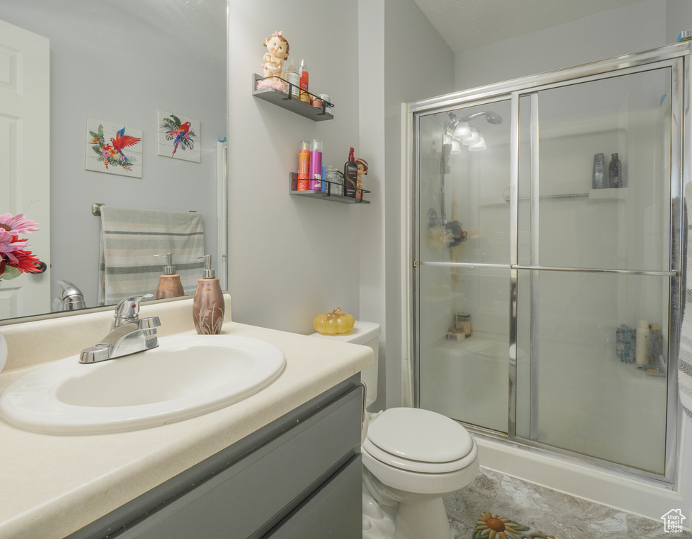 Bathroom with vanity and a stall shower