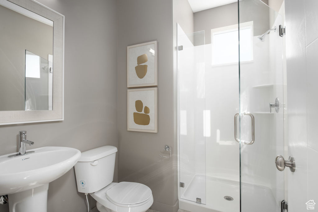 Full bathroom featuring toilet and a shower stall