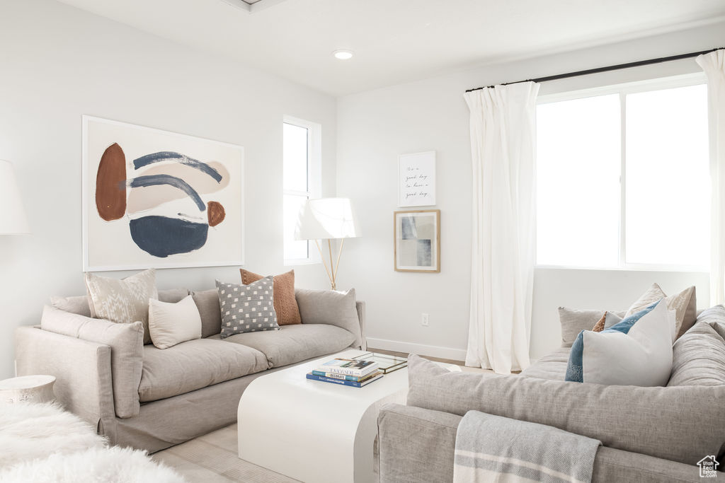 Living area featuring baseboards and recessed lighting