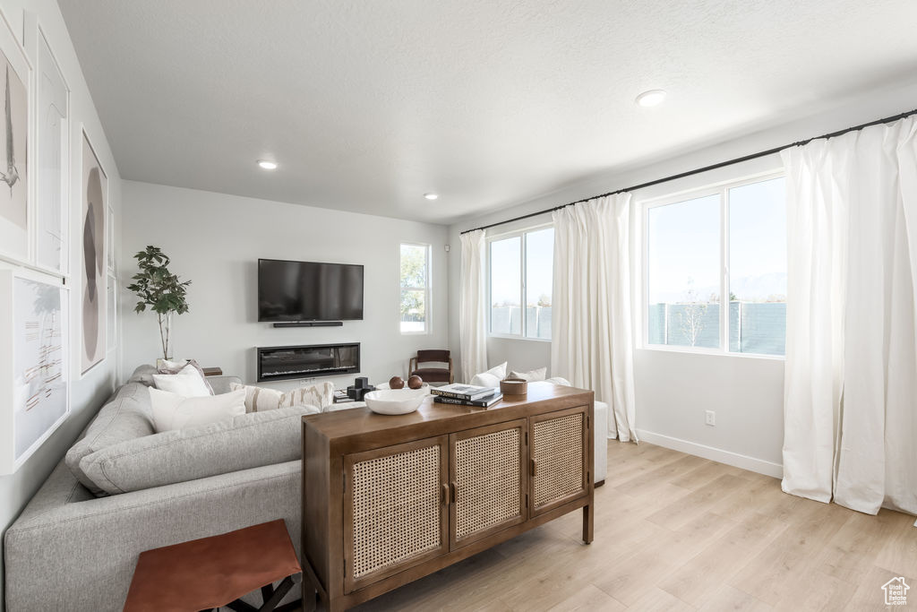 Living room featuring light wood-style floors and recessed lighting