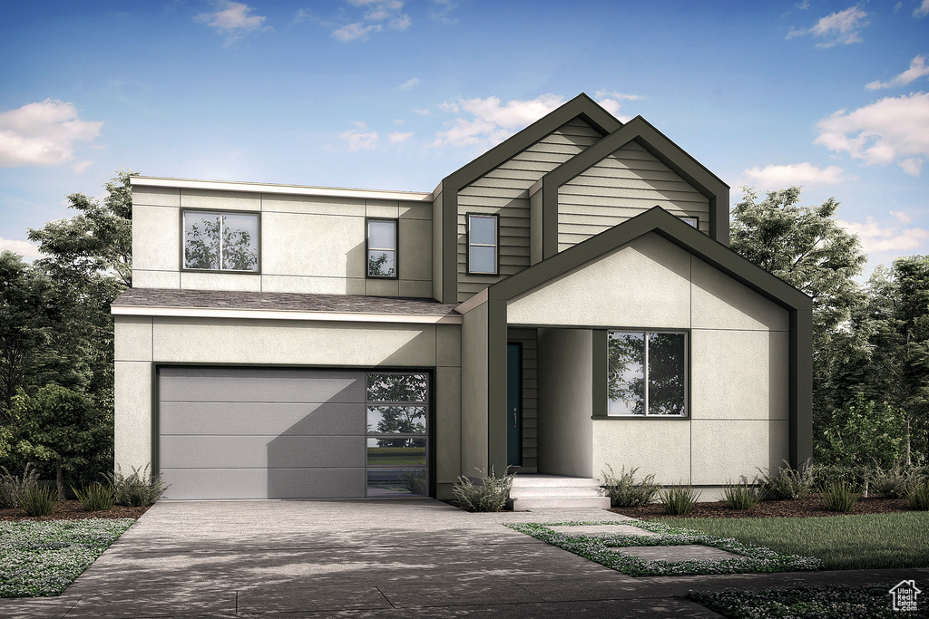 View of front facade featuring concrete driveway, stucco siding, and an attached garage