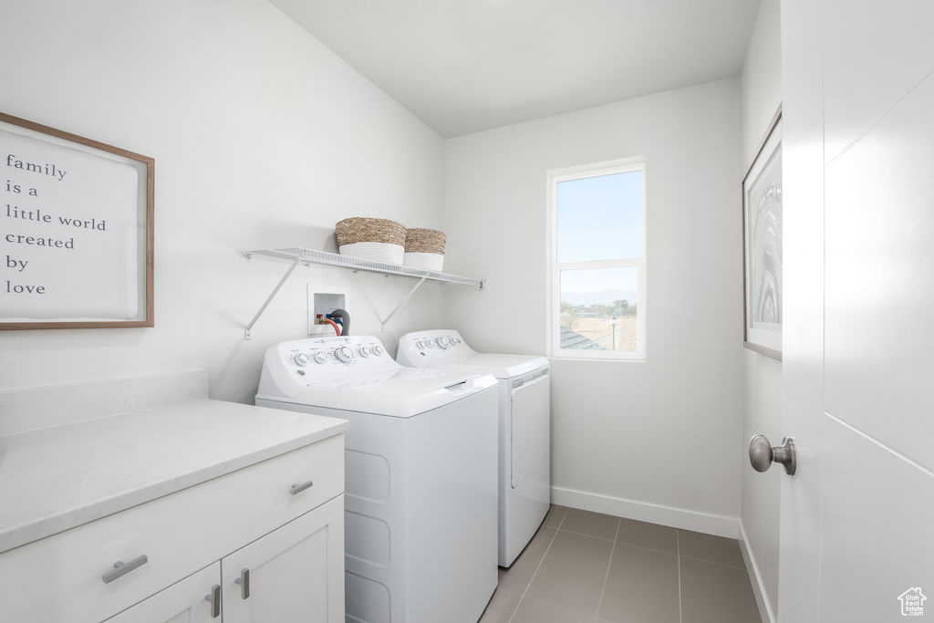 Laundry room with independent washer and dryer, cabinet space, and light tile patterned floors