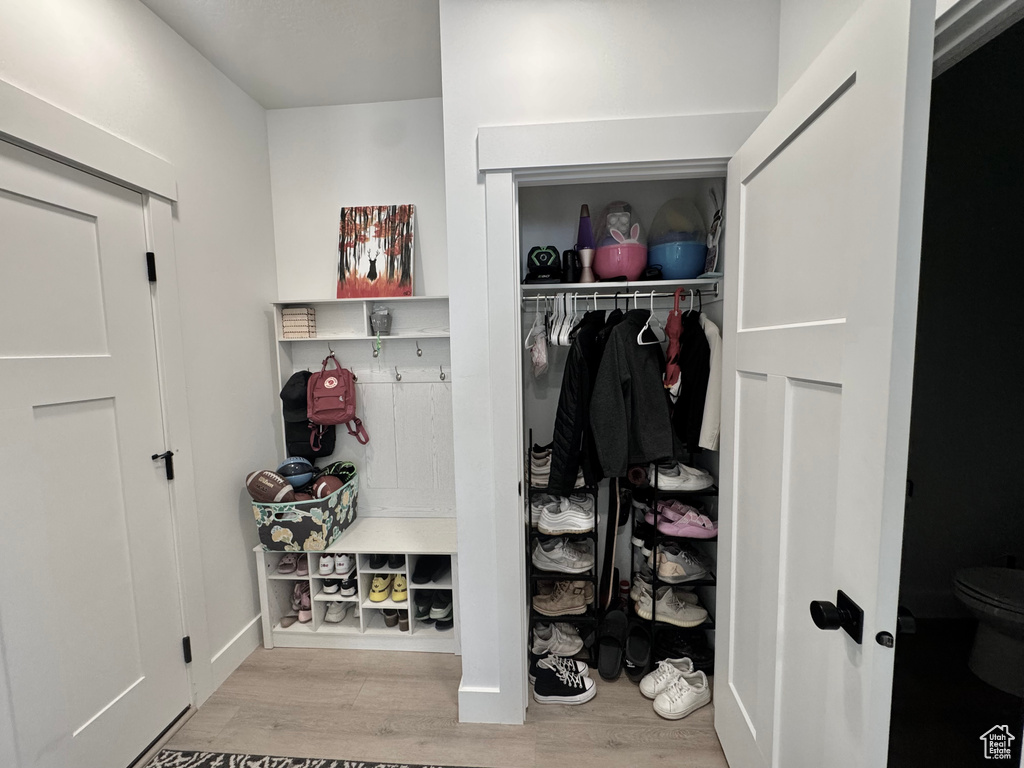 Mudroom with wood finished floors and baseboards