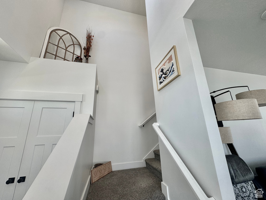 Staircase with carpet flooring and baseboards