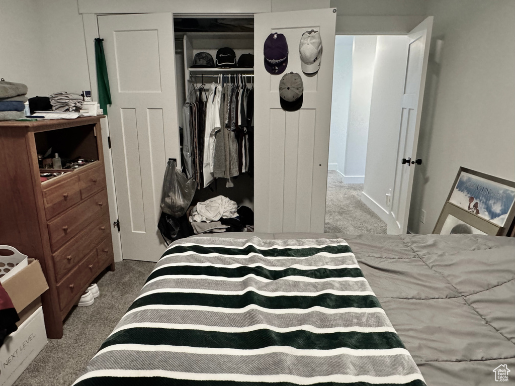 Bedroom with carpet and a closet