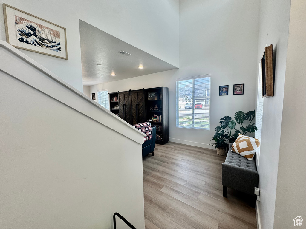 Stairway with wood finished floors and baseboards