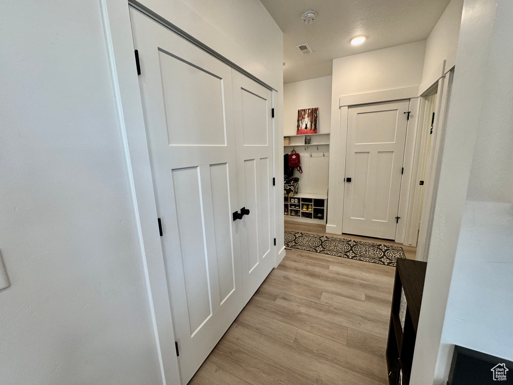 Corridor featuring light wood-style flooring