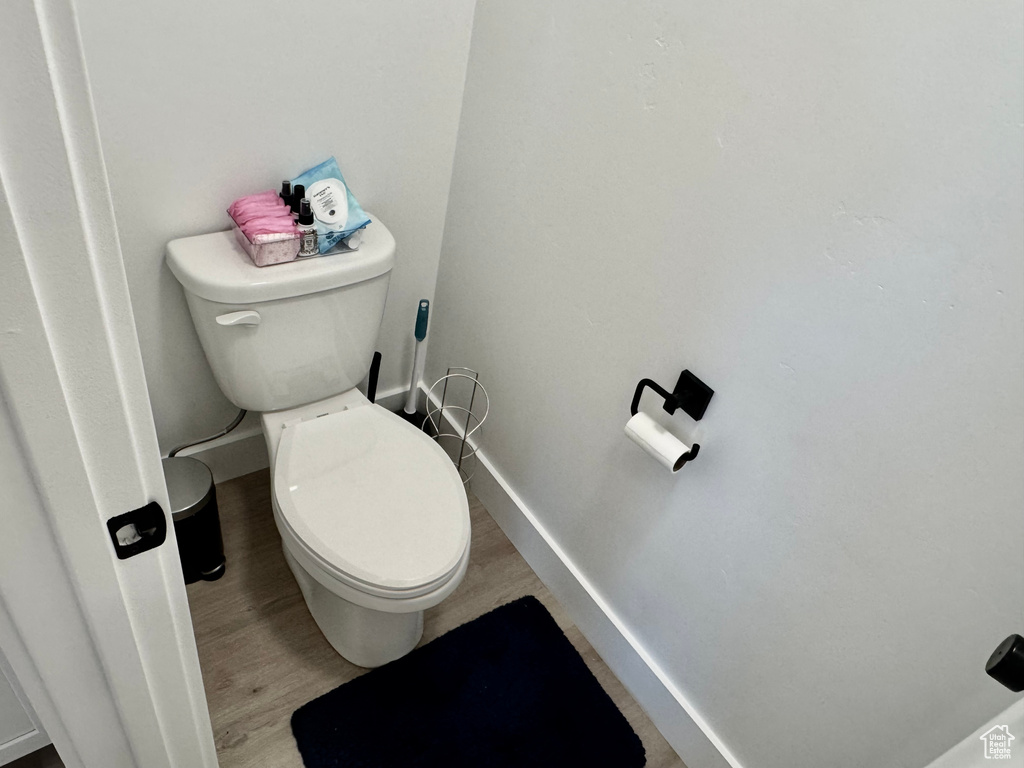Bathroom featuring toilet and wood finished floors