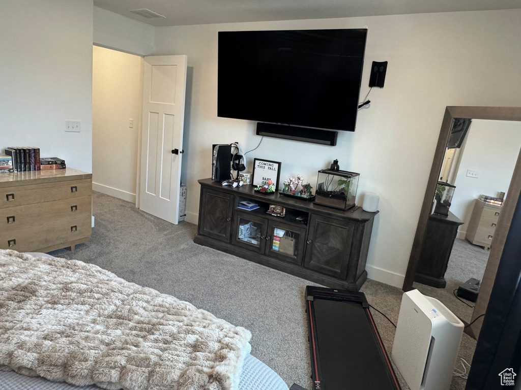 Carpeted bedroom featuring baseboards