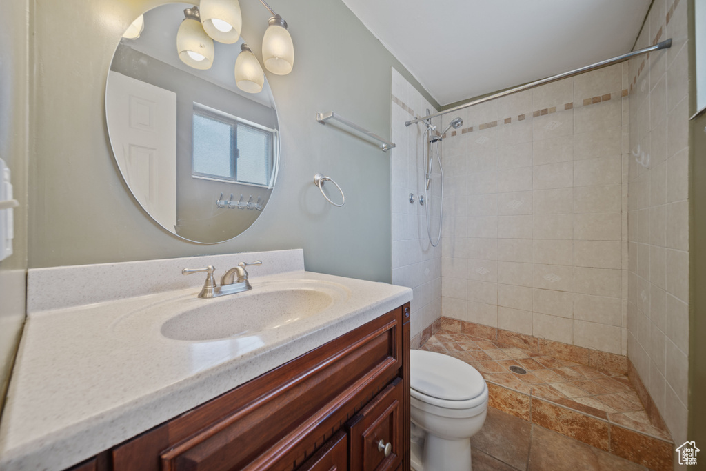 Bathroom with vanity and a tile shower