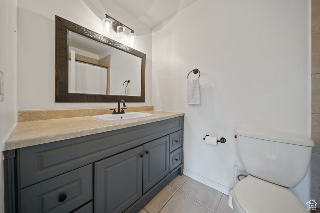 Full bath featuring vanity and tile patterned flooring