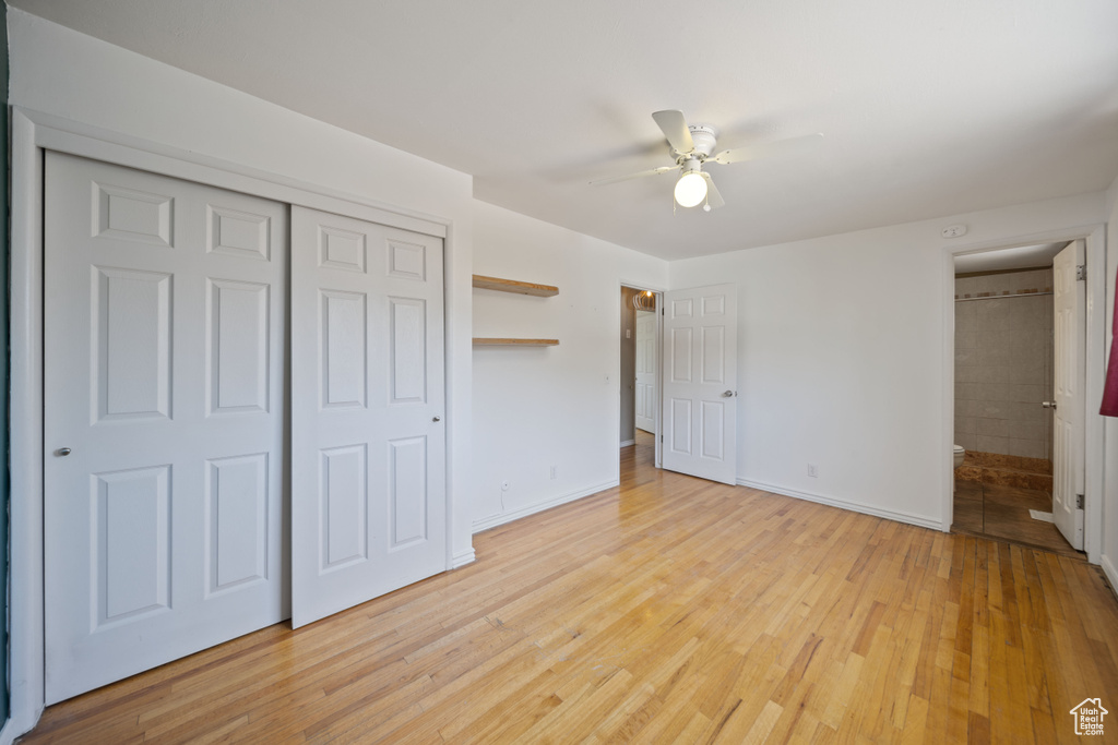Unfurnished bedroom with light wood-style flooring, a closet, and ceiling fan