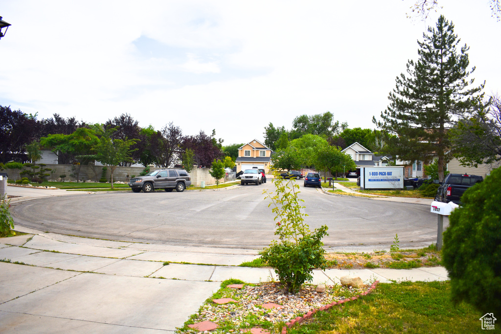 View of asphalt road with curbs and sidewalks