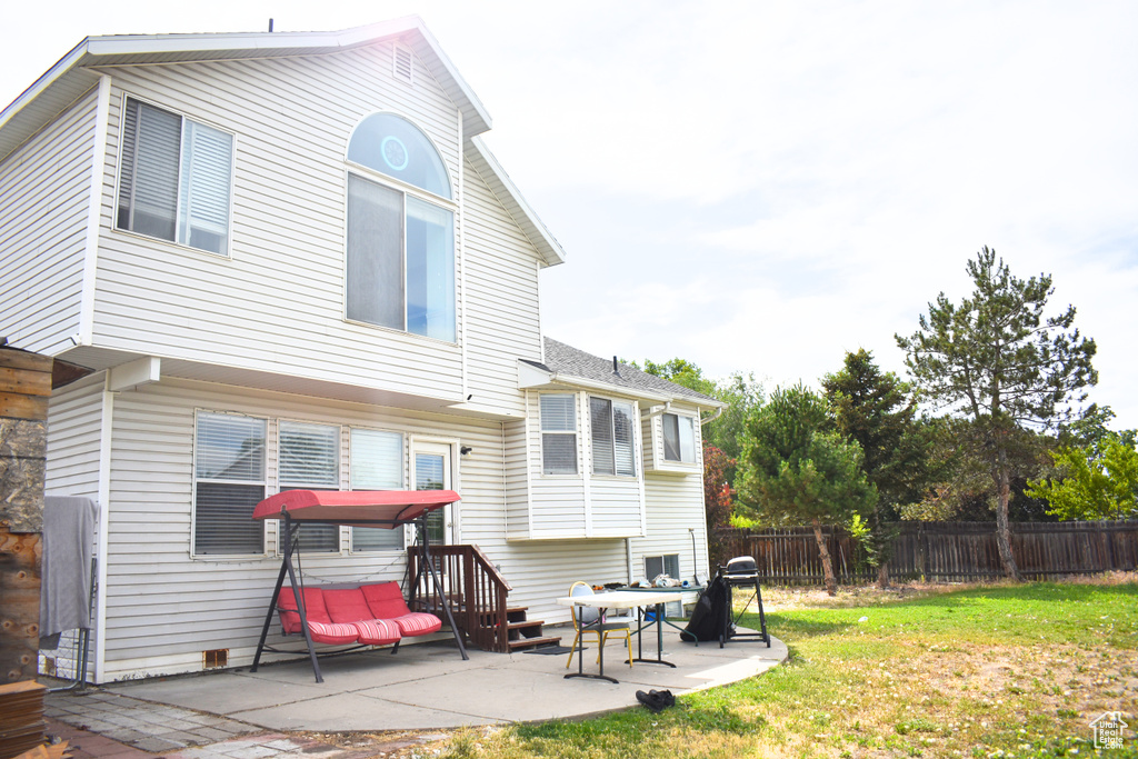 Back of property with a patio