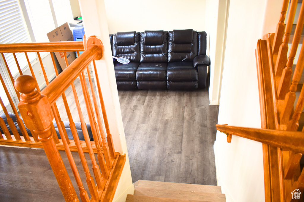 Stairs featuring wood finished floors
