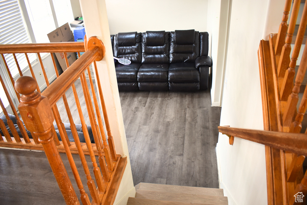 Stairs featuring wood finished floors