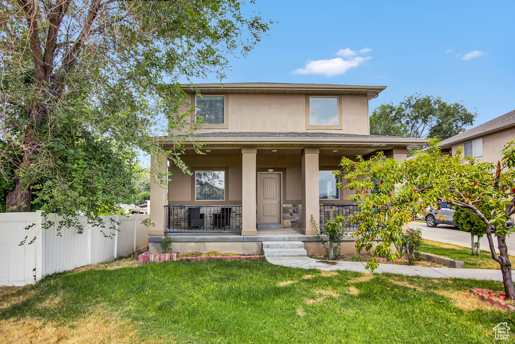 View of front of property featuring a porch and stucco siding