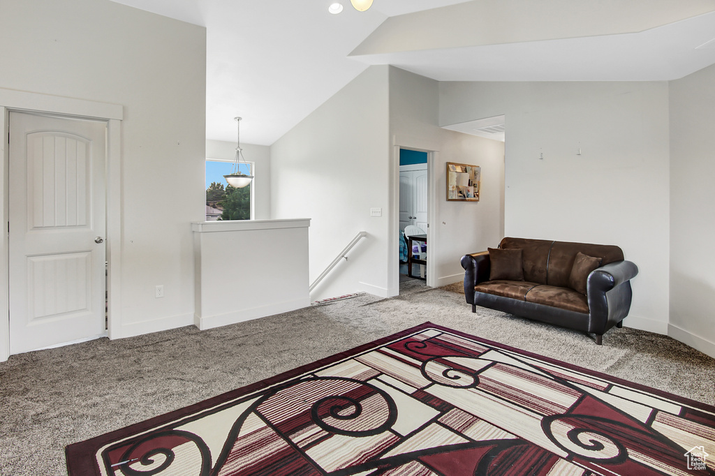Living room with vaulted ceiling and carpet flooring