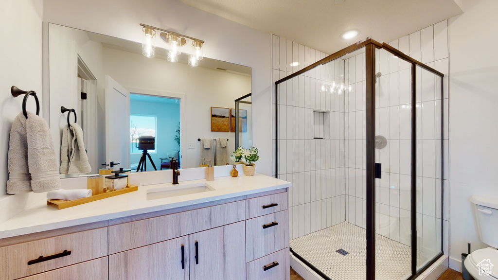 Full bathroom featuring vanity and a shower stall